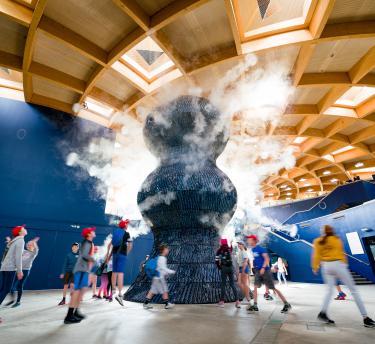 Kids running around Infinity Blue sculpture